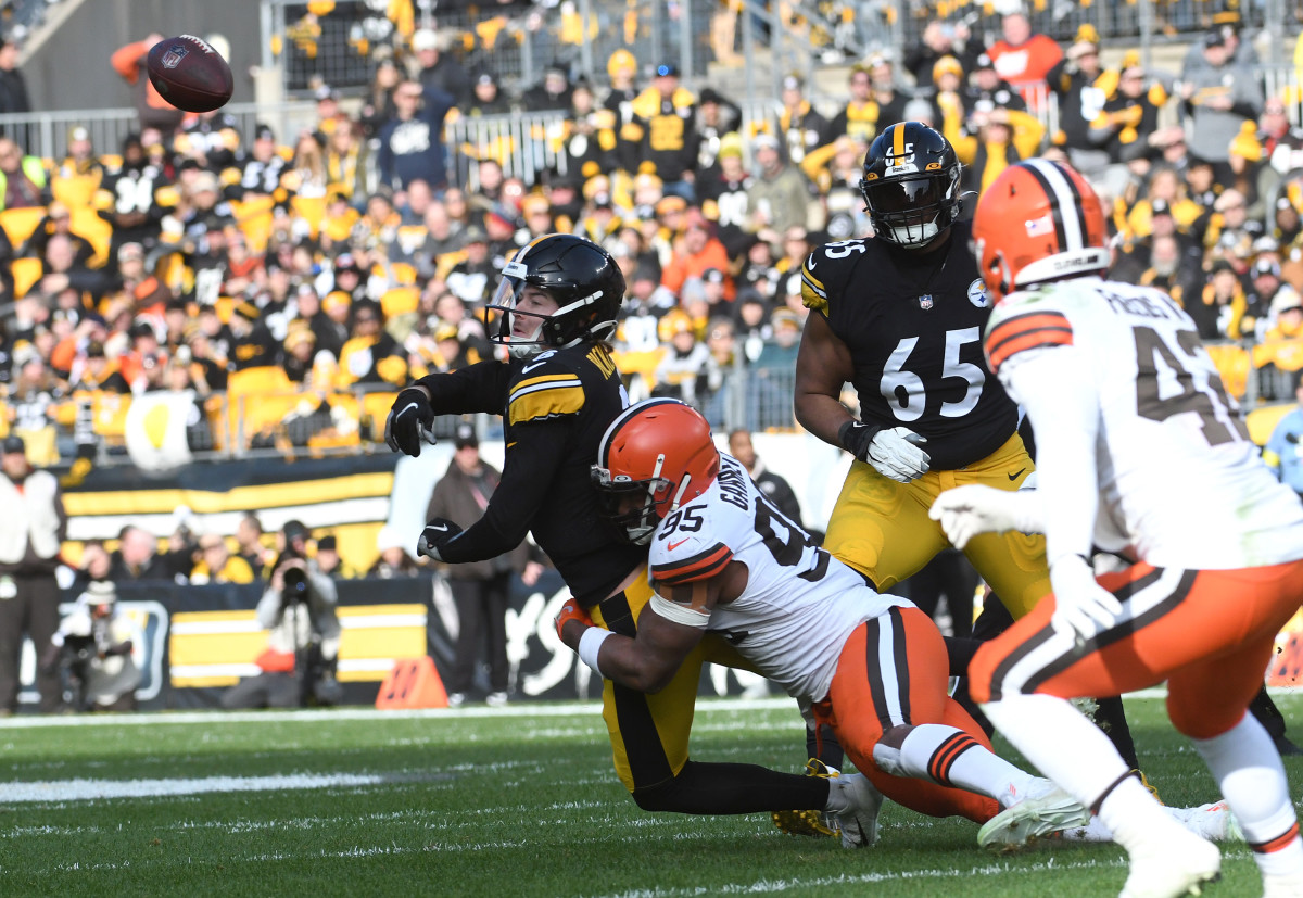 Pittsburgh Steelers quarterback Kenny Pickett releases the ball as he is hit by Cleveland Browns defensive end Myles Garrett