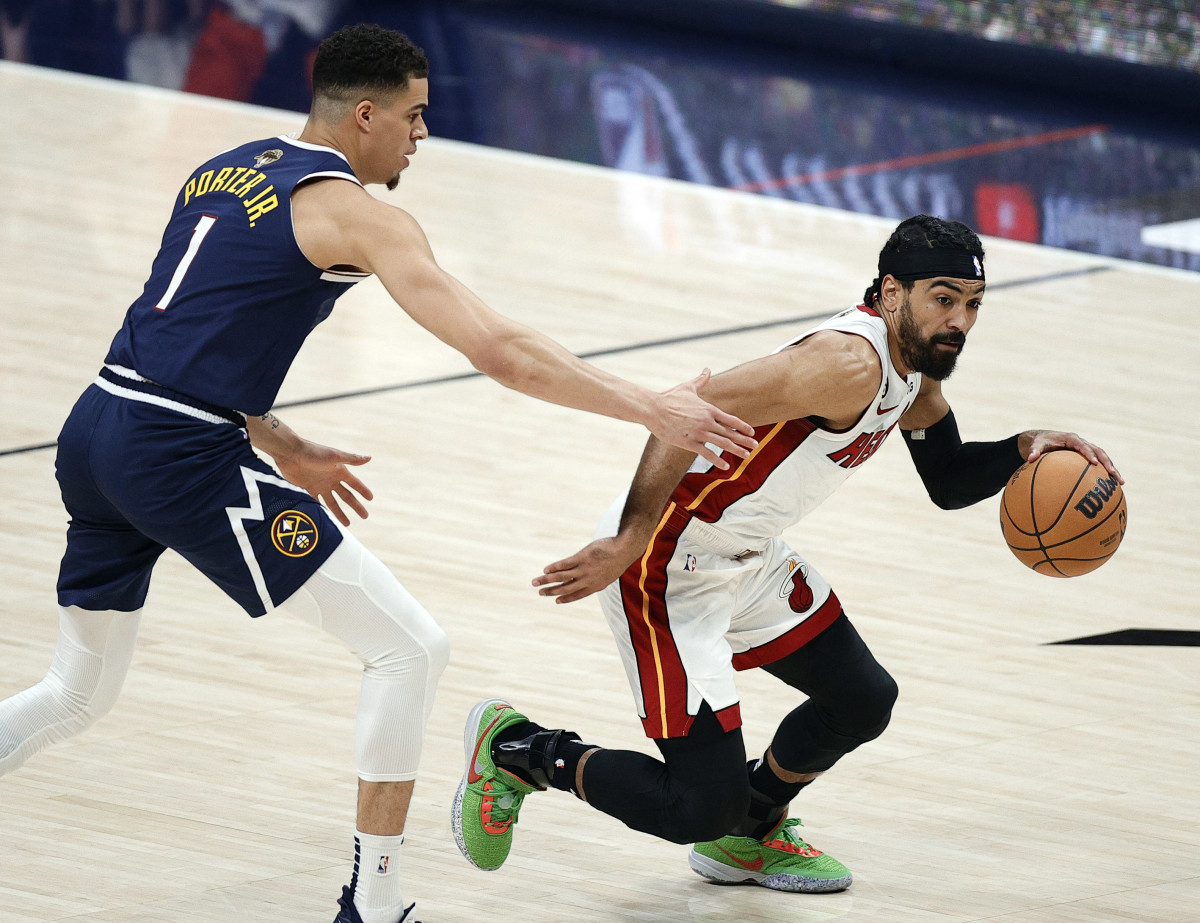 Heat guard Gabe Vincent controls the ball against Nuggets forward Michael Porter Jr. in Game 2 of the NBA Finals