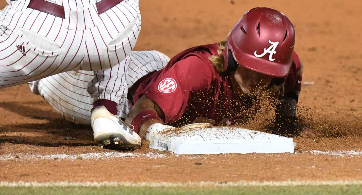 Alabama hitter Jim Jarvis (10) dives back into first safely on a pickoff play against Troy at Sewell-Thomas Stadium in Tuscaloosa, Ala., Saturday June 4, 2023, in the winners bracket game of the NCAA Regional Baseball Tournament.