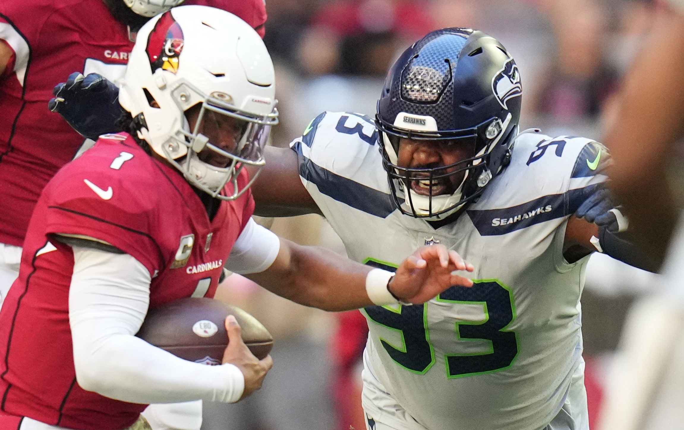 Seattle Seahawks defensive end Shelby Harris (93) closes in on Arizona Cardinals quarterback Kyler Murray (1) at State Farm Stadium.