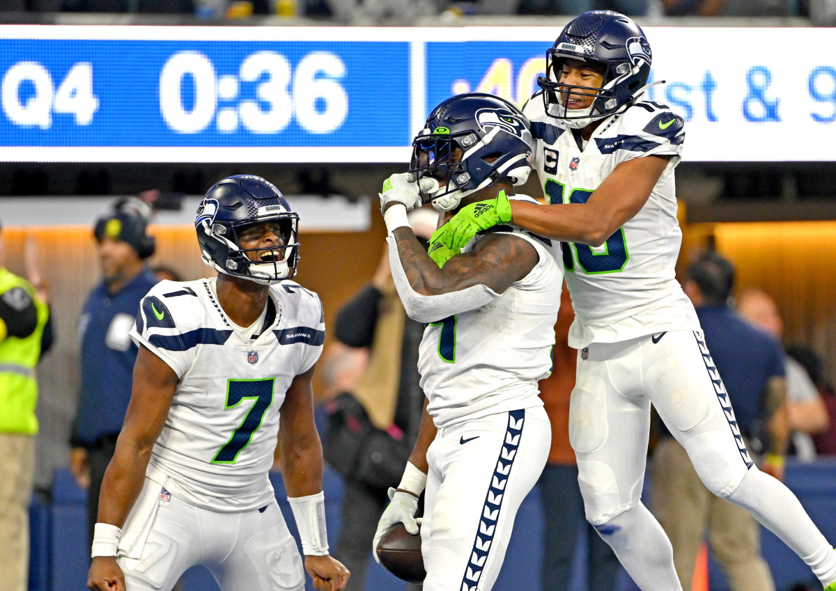 Geno Smith, DK Metcalf and Tyler Lockett celebrate a Seahawks touchdown