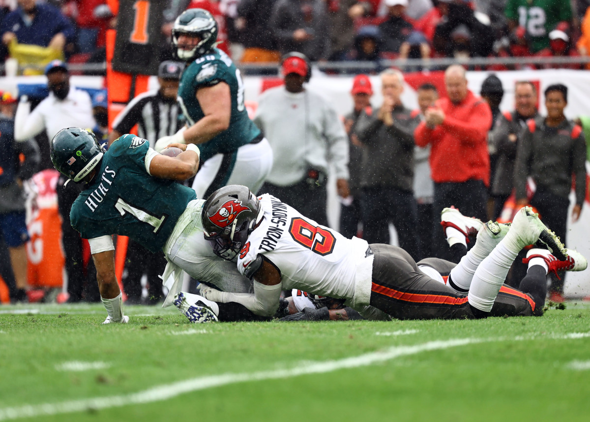 linebacker Joe Tryon-Shoyinka sacks Philadelphia Eagles quarterback Jalen Hurts, holding onto his legs