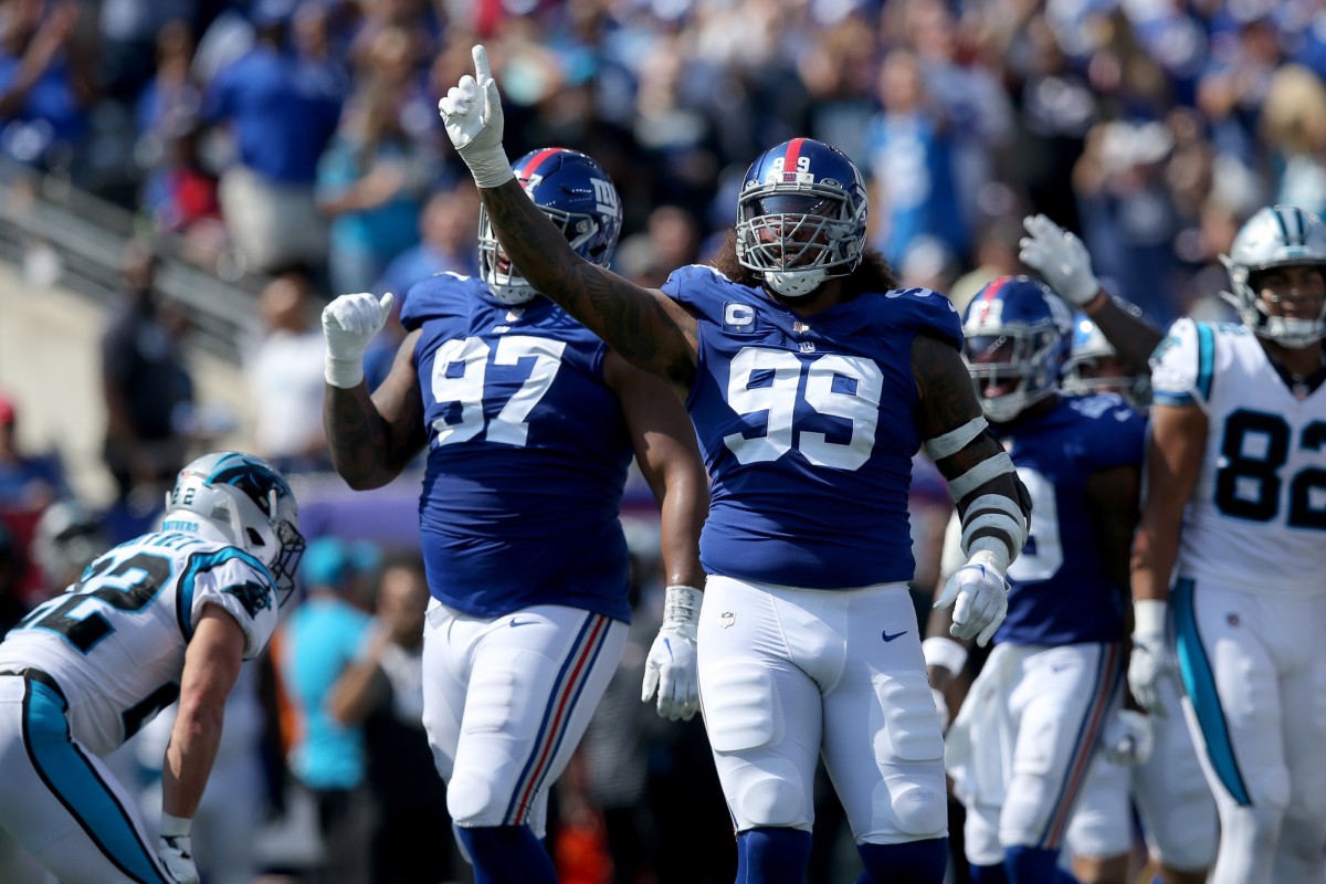 Sep 18, 2022; East Rutherford, New Jersey, USA; New York Giants defensive end Leonard Williams (99) and defensive tackle Dexter Lawrence (97) celebrate after Carolina Panthers turn the ball over on downs during the second quarter at MetLife Stadium.