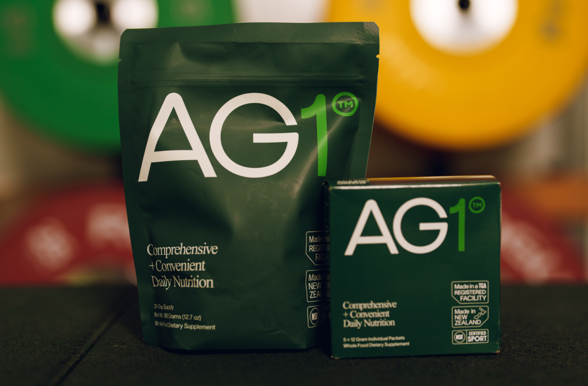 A bag and a box of travel packs of AG1 greens powder