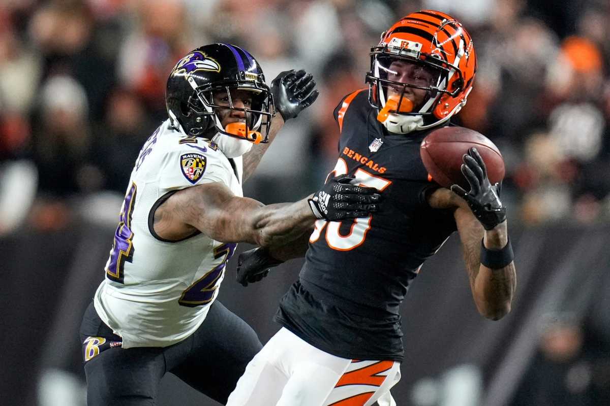Cincinnati Bengals wide receiver Tee Higgins (85) is unable to hold onto a pass under pressure from Baltimore Ravens cornerback Marcus Peters (24) in the third quarter during an NFL wild-card playoff football game between the Baltimore Ravens and the Cincinnati Bengals, Sunday, Jan. 15, 2023, at Paycor Stadium in Cincinnati. The Bengals advanced to the Divisional round of the playoffs with a 24-17 win over the Ravens.