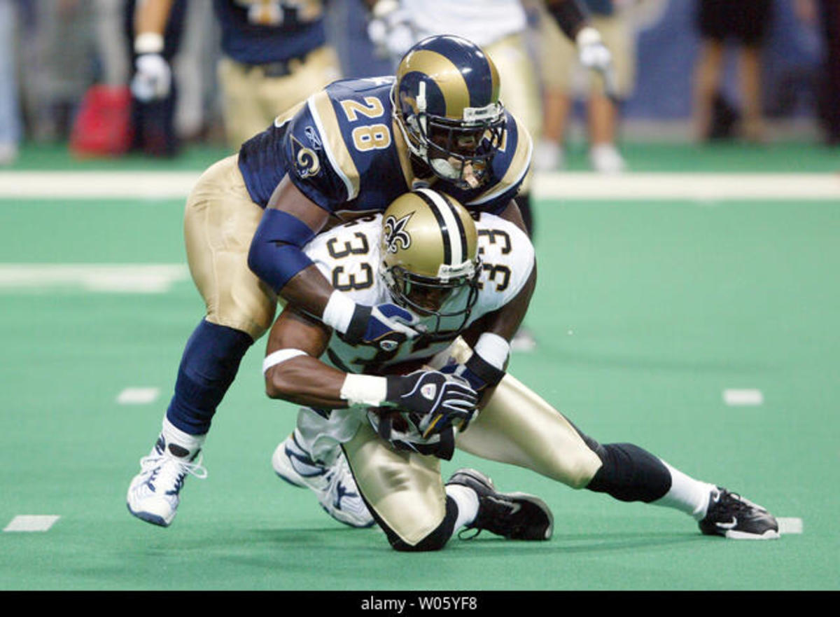 Saints CB Ashley Ambrose (33) recovers a fumble against the St. Louis Rams during a 2004 game. Credit: Alamy.com