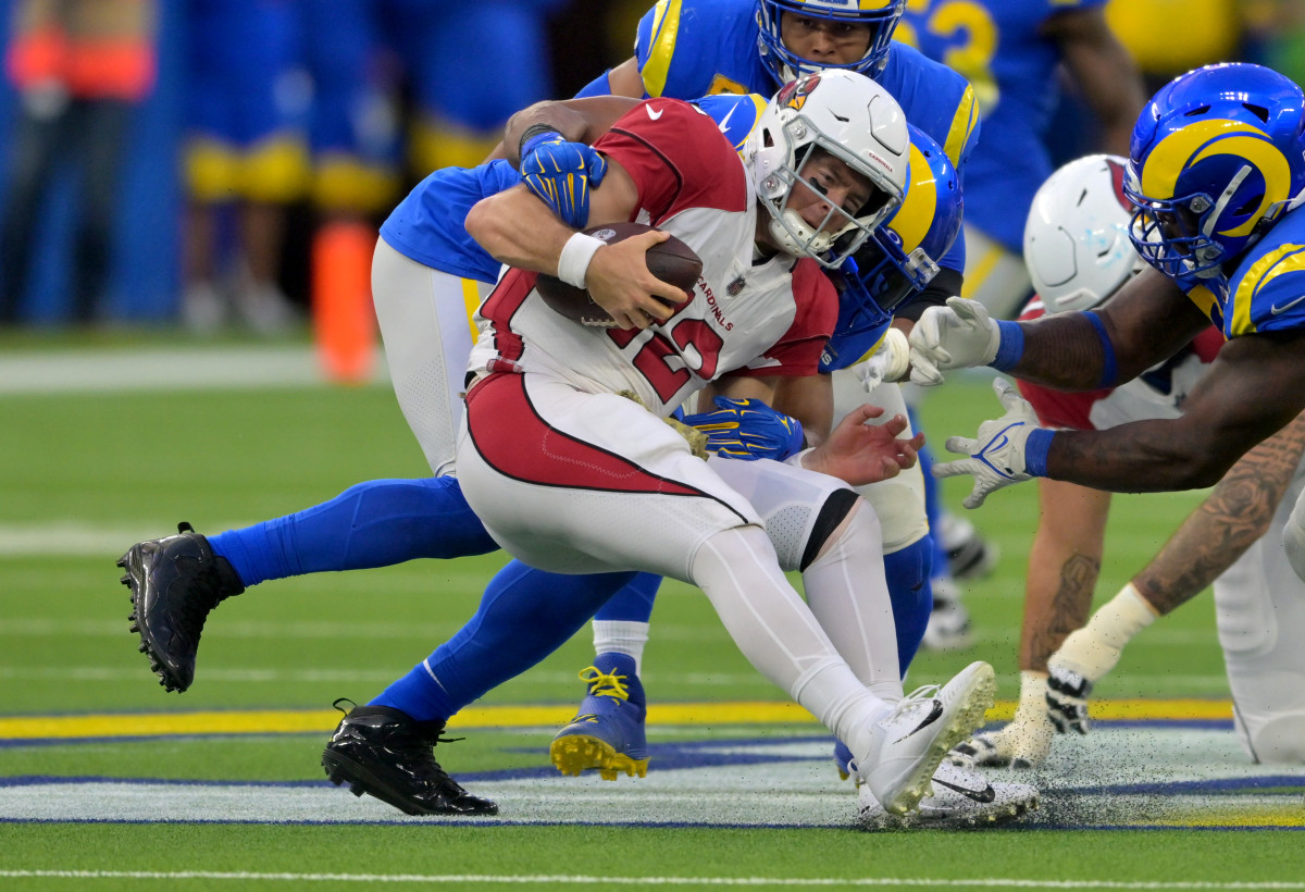 Bobby Wagner tackles a Cardinals player holding the ball
