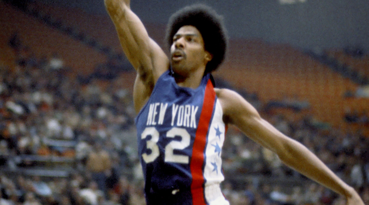 Forward Julius Erving dunks for the Nets of the American Basketball Association.