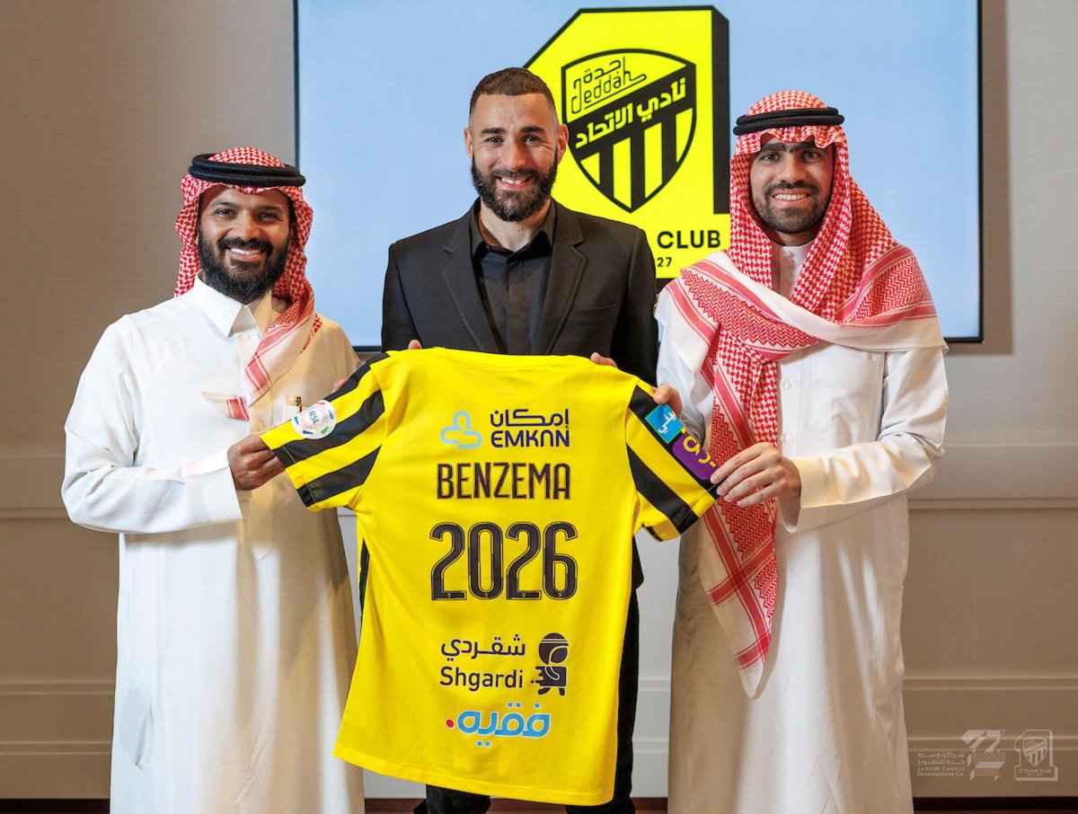 Karim Benzema pictured holding an Al-Ittihad jersey after signing a three-year contract with the Saudi Pro League club in June 2023