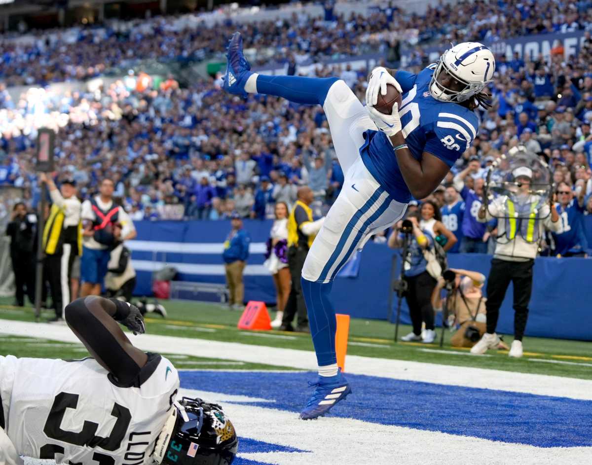 Indianapolis Colts tight end Jelani Woods catches the ball in the air with both legs off the ground