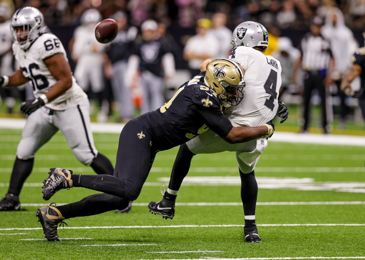Oct 30, 2022; New Orleans Saints defensive end Cameron Jordan (94) hits Las Vegas Raiders quarterback Derek Carr (4) as he throws. Mandatory Credit: Stephen Lew-USA TODAY