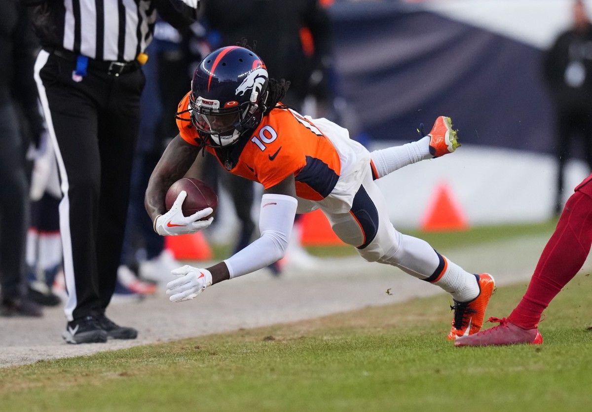 Denver Broncos wide receiver Jerry Jeudy (10) dives with the ball in the second half against the Arizona Cardinals at Empower Field at Mile High.