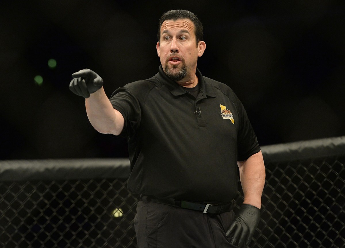Former MMA referee "Big" John McCarthy officiating a UFC fight.