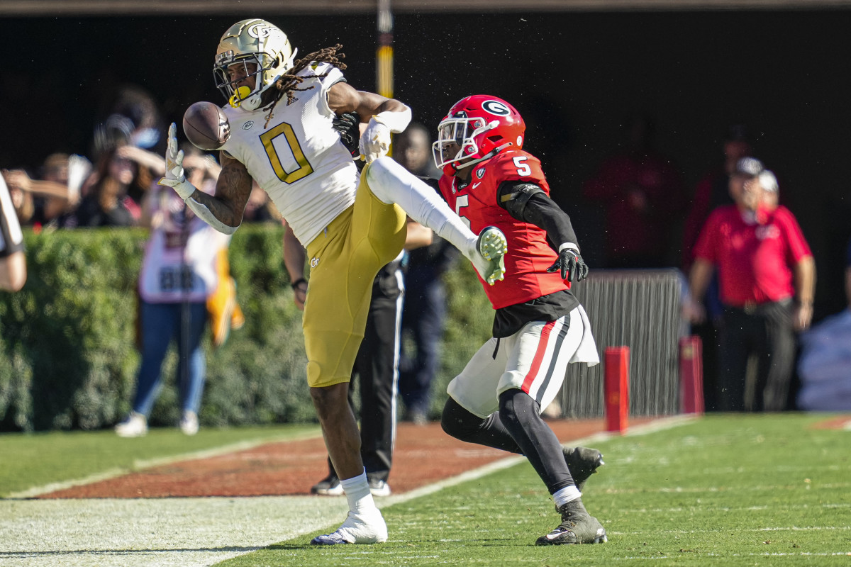 Nov 26, 2022; Athens, Georgia, USA; Georgia Tech Yellow Jackets wide receiver E.J. Jenkins (0) tries to make a catch against Georgia Bulldogs defensive back Kelee Ringo (5) during the first half at Sanford Stadium. Mandatory Credit: Dale Zanine-USA TODAY Sports