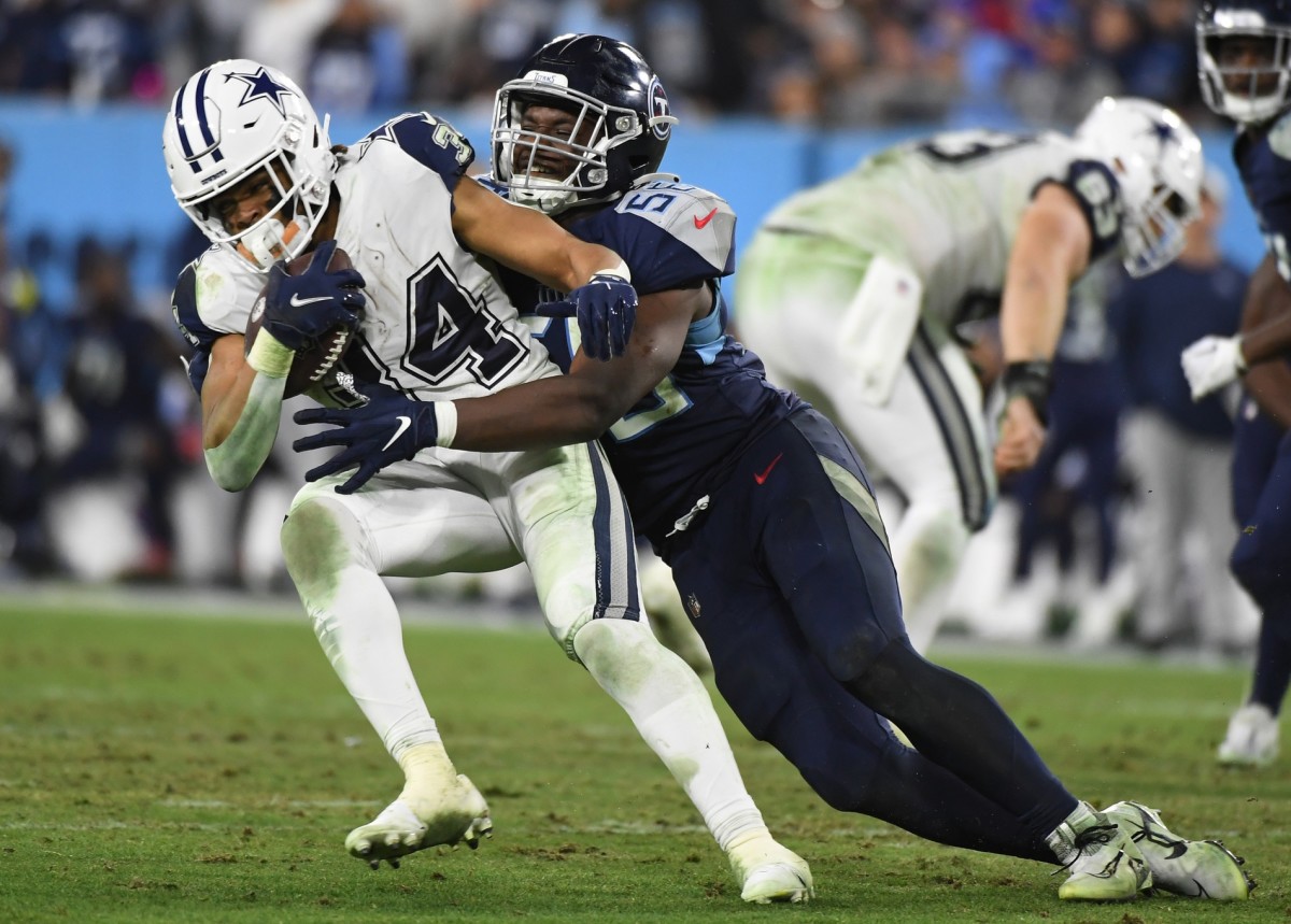 Dallas running back Malik Davis (34) is tackled by Tennessee Titans linebacker Monty Rice (56) in a game last December. (Christopher Hanewinckel-USA TODAY Sports)