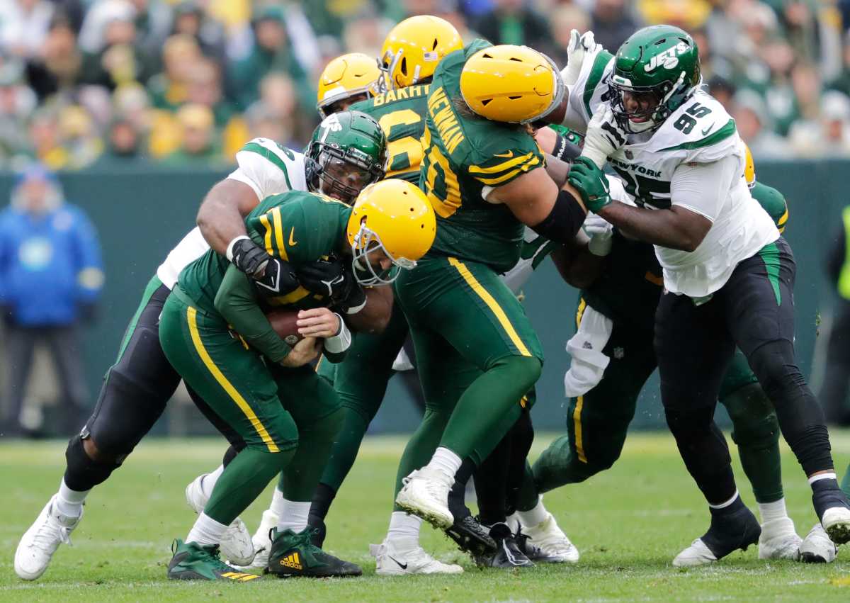 defensive tackle Sheldon Rankins sacks QB Aaron Rodgers as the Packers and Jets offensive and defensive lines fight in the back