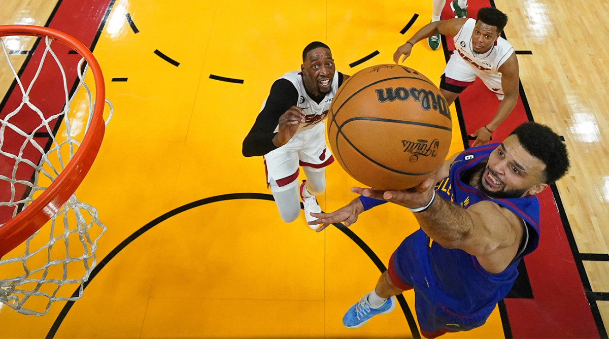 Nuggets’ Jamal Murray shoots layup over Heat’s Bam Adebayo in Game 3 of 2023 NBA Finals.