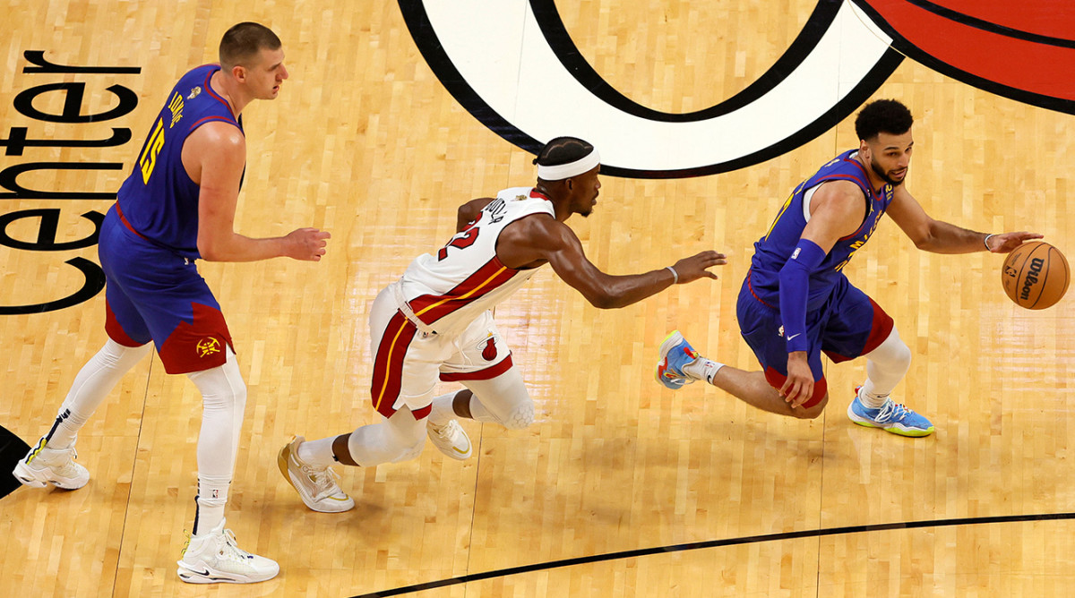 Nuggets’ Nikola Jokić, Jamal Murray run a pick-and-roll against Heat’s Jimmy Butler in Game 3 of the 2023 NBA Finals.