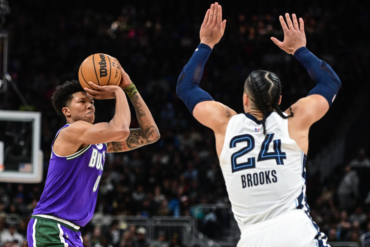 Apr 7, 2023; Milwaukee, Wisconsin, USA; Milwaukee Bucks guard Marjon Beauchamp (0) takes a shot against Memphis Grizzlies guard Dillon Brooks (24) in the fourth quarter at Fiserv Forum. Mandatory Credit: Benny Sieu-USA TODAY Sports