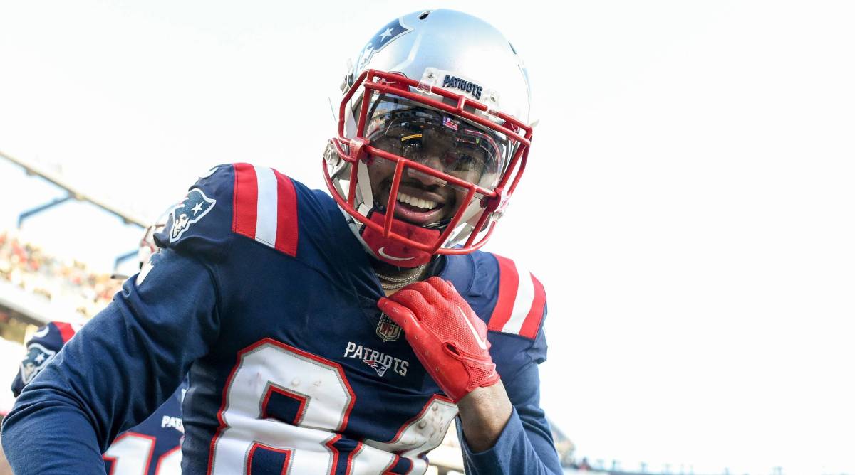 Patriots wide receiver Kendrick Bourne smiles while celebrating a touchdown during a game.