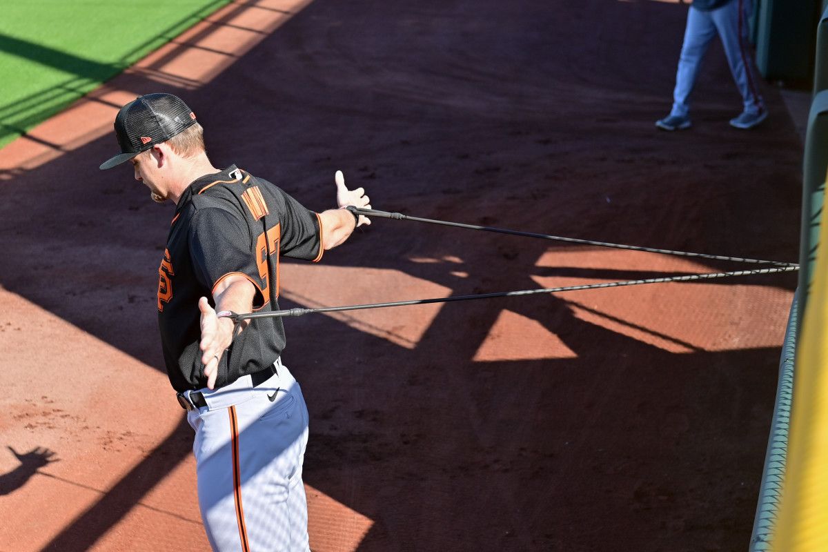 SF Giants starting pitcher Keaton Winn warms up during a Spring Training workout. (2023)