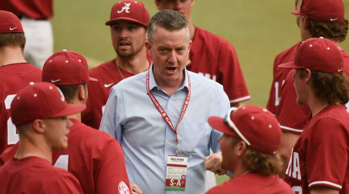 Alabama athletic director Greg Byrne talks to baseball players before a game
