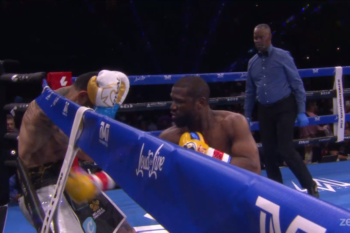 Floyd Mayweather connects with a body punch during his exhibition boxing match with John Gotti III in Sunrise, Florida.