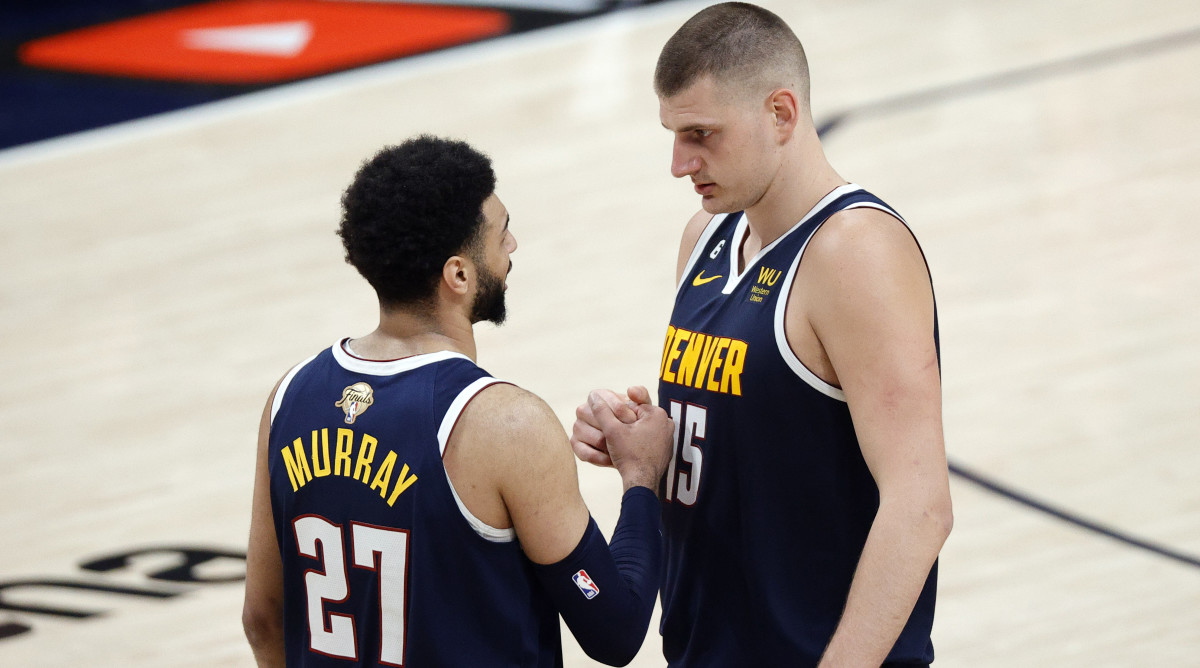 Nuggets center Nikola Jokic and guard Jamal Murray react to a play against the Heat in Game 2 of the NBA Finals.