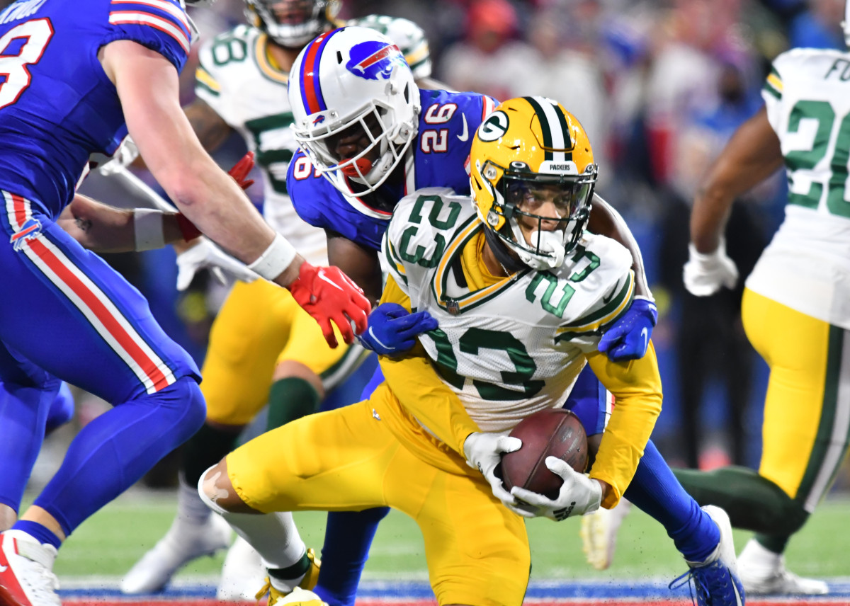 Green Bay Packers cornerback Jaire Alexander is tackled while holding the ball