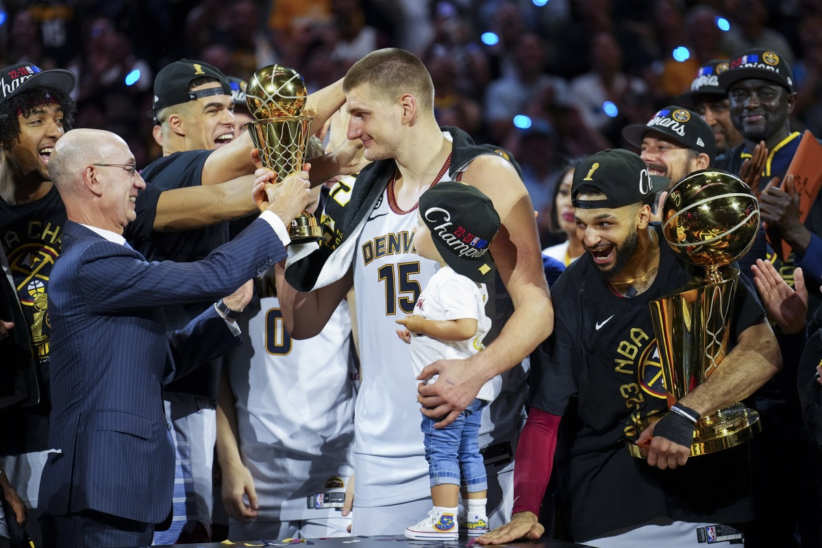 NBA commissioner Adam Silver awards Nikola Jokić with the NBA Finals MVP award.