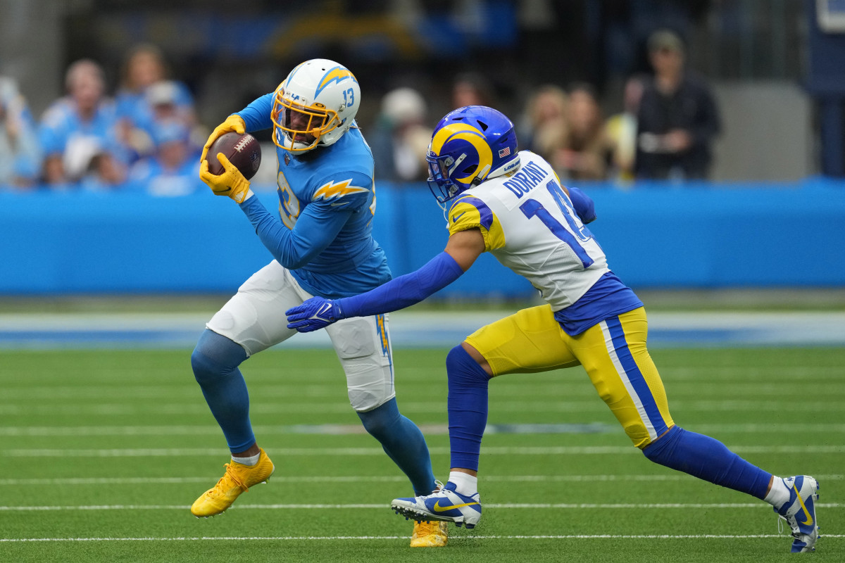 Keenan Allen runs with the ball as cornerback Cobie Durant reaches to try to tackle him