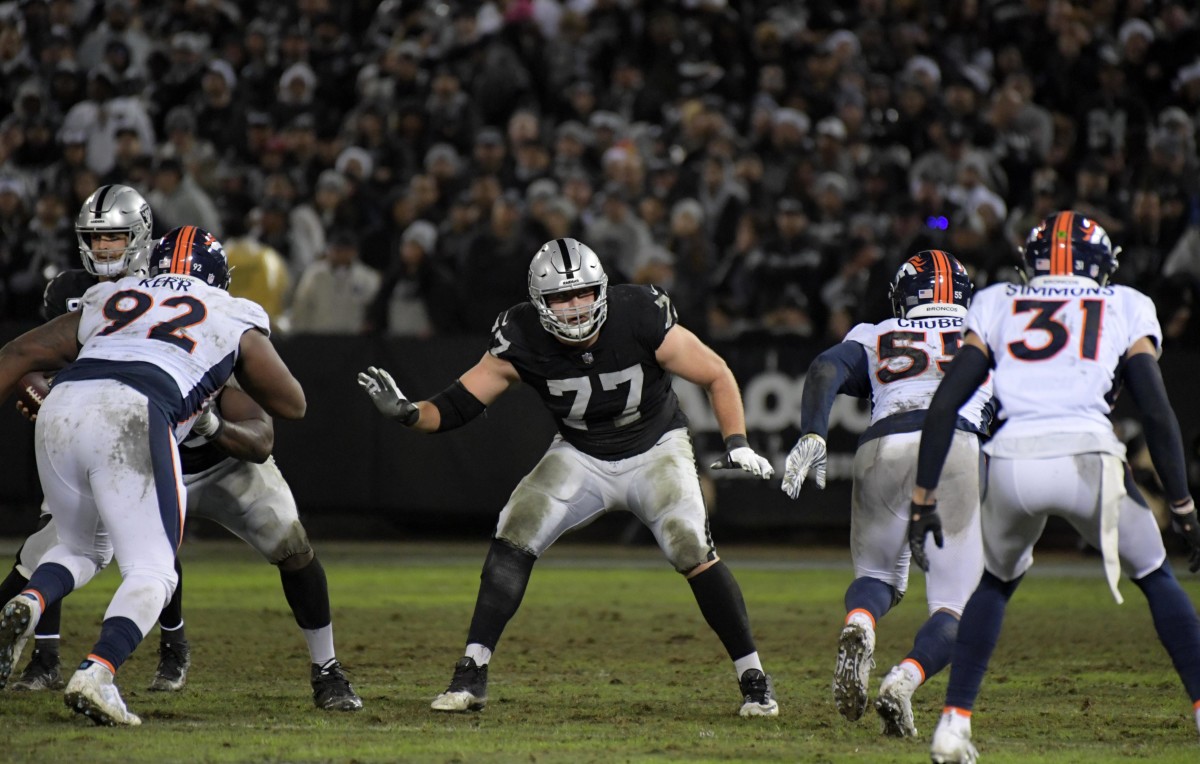 Oakland Raiders offensive tackle Kolton Miller puts his arms out to the side as Broncos players line up across from him