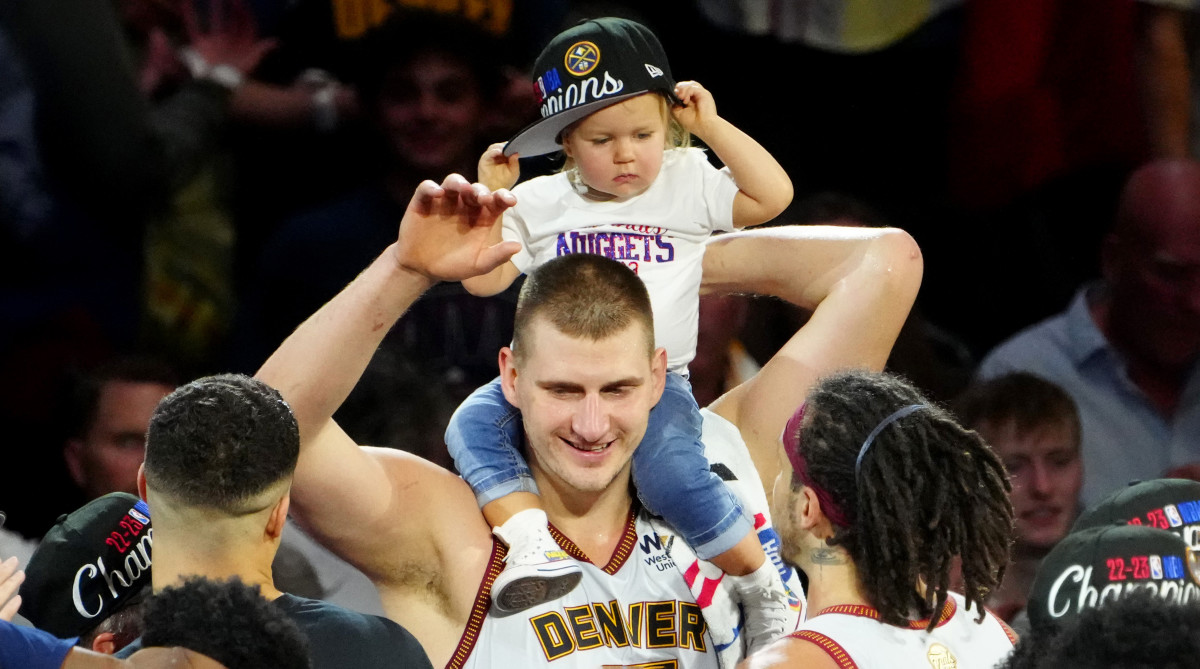 Denver Nuggets center Nikola Jokic celebrates winning the 2023 NBA Finals with his baby.