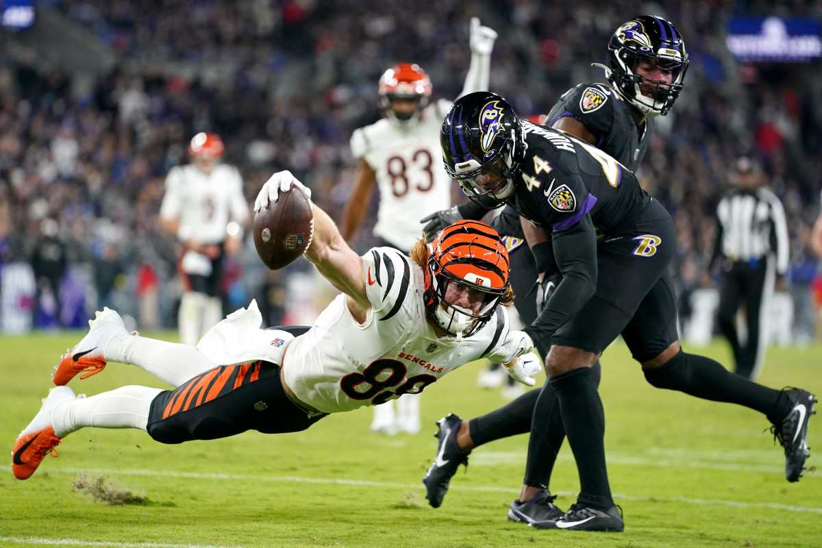 Hayden Hurst reaches out with one hand as he falls to get the ball over a line as a Ravens defender tries to tackle him