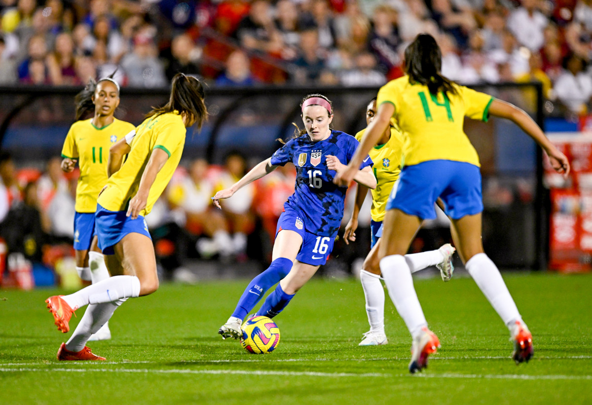 USWNT player Rose Lavelle controls the ball against Brazil defenders in the SheBelieves Cup.
