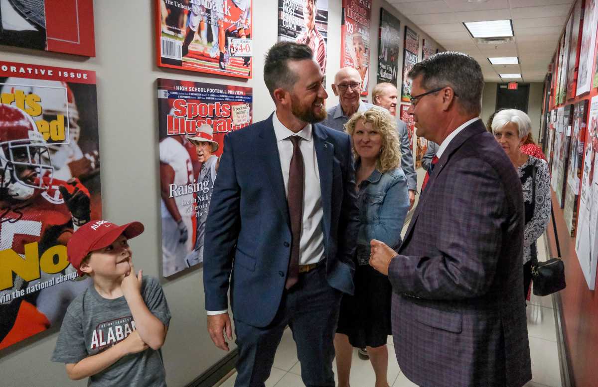 The University of Alabama introduced Rob Vaughn as the new head baseball coach Tuesday, June 13, 2023. Wyatt Vaughn, watches as his father talks with Chris Stewart who was emcee for the press conference.