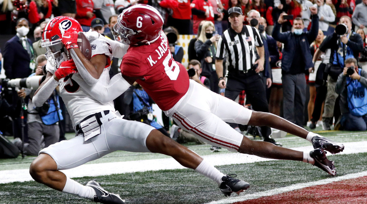 Georgia wide receiver Adonai Mitchell brings down a touchdown catch while being guarded by Alabama defensive back Khyree Jackson.