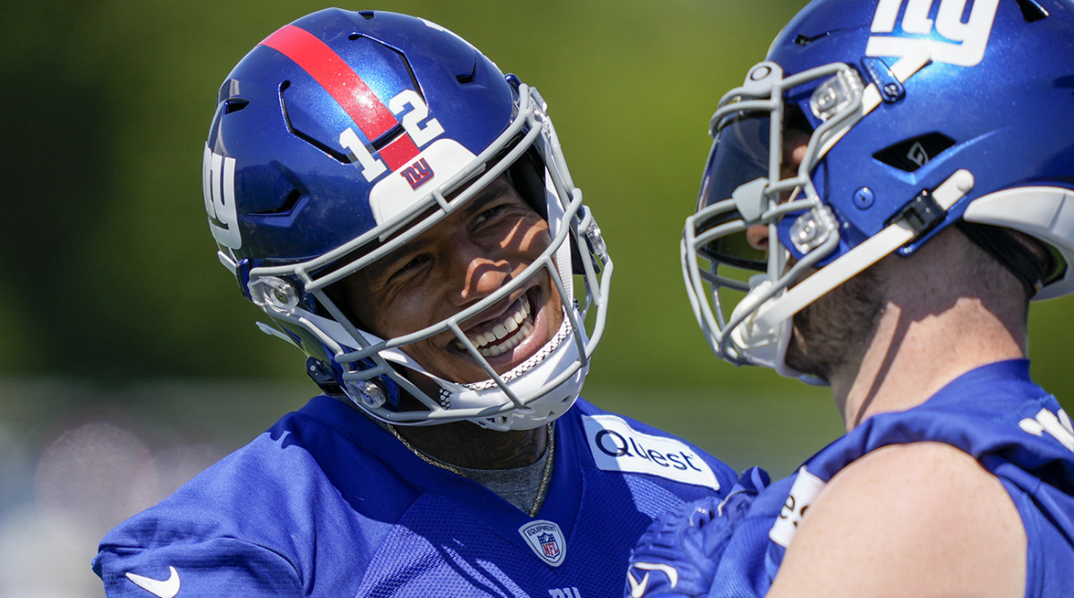 Giants tight ends Darren Waller, left, and Daniel Bellinger, right, laugh on the sidelines of practice.