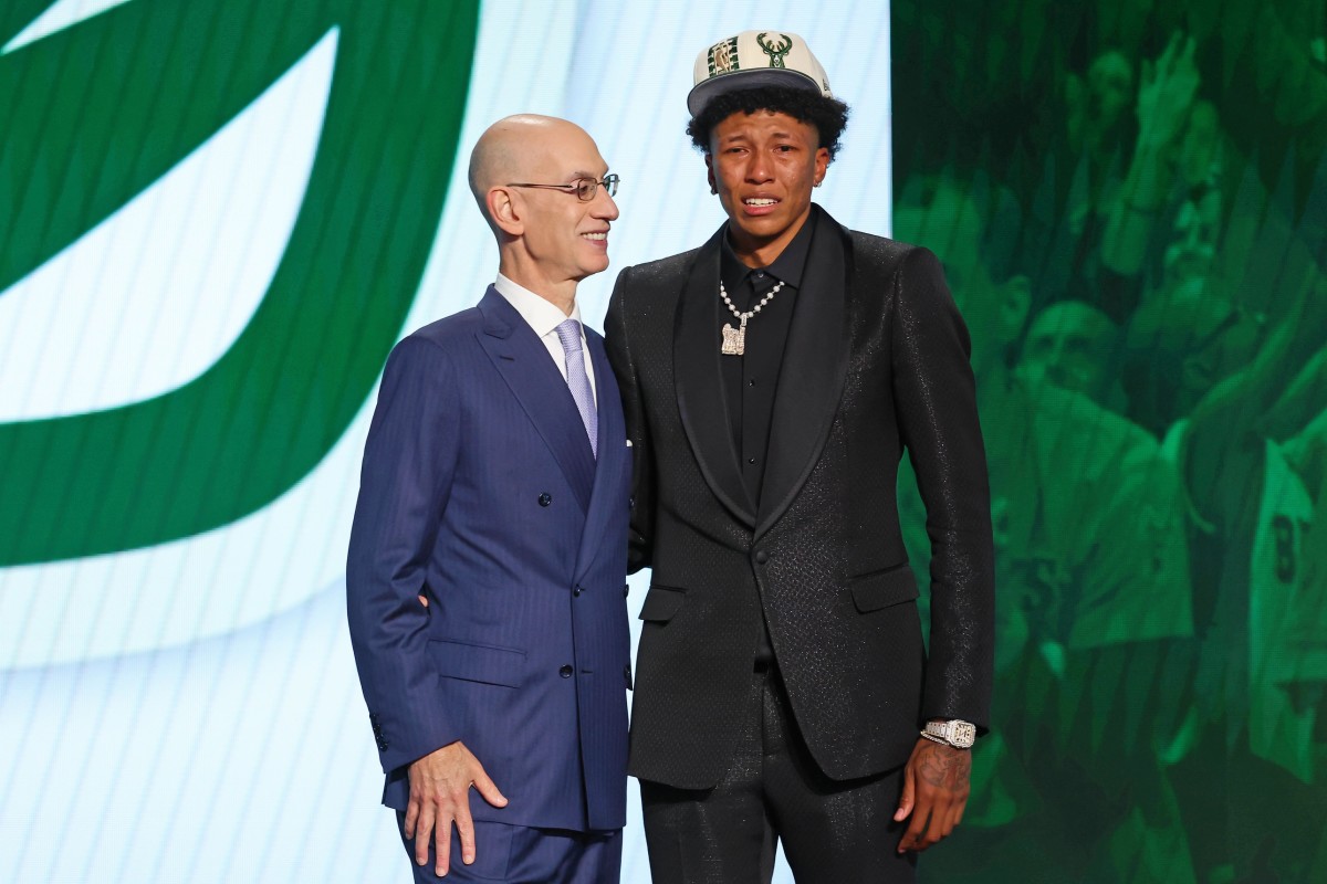 MarJon Beauchamp (G League Ignite) poses with NBA commissioner Adam Silver after being selected as the number twenty-four overall pick by the Milwaukee Bucks in the first round of the 2022 NBA Draft