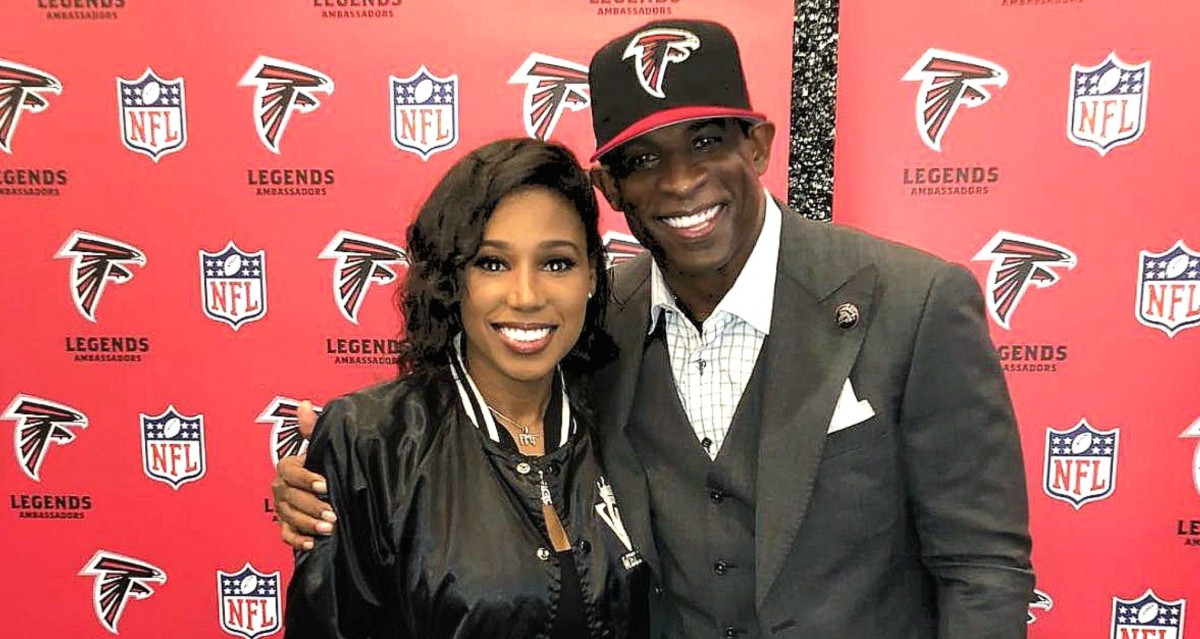 Deiondra Sanders poses with her father, Deion, at Falcons Legends event