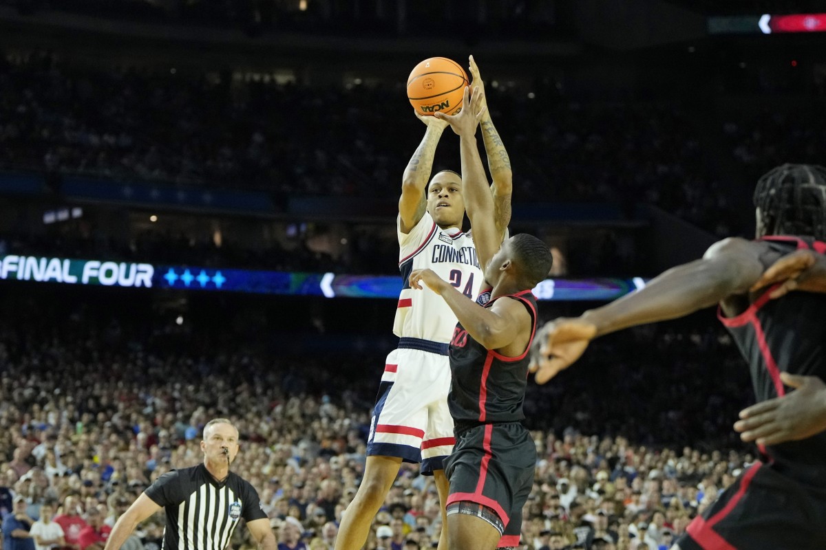 Connecticut Huskies guard Jordan Hawkins (24) shoots the ball against San Diego State Aztecs guard Lamont Butler (5) during the first half in the national championship game of the 2023 NCAA Tournament at NRG Stadium.