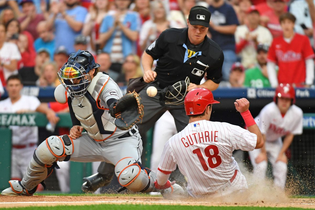Philadelphia Phillies center fielder Dalton Guthrie slides safely into home as throw gets past Detroit Tigers catcher Eric Haase. (2023)