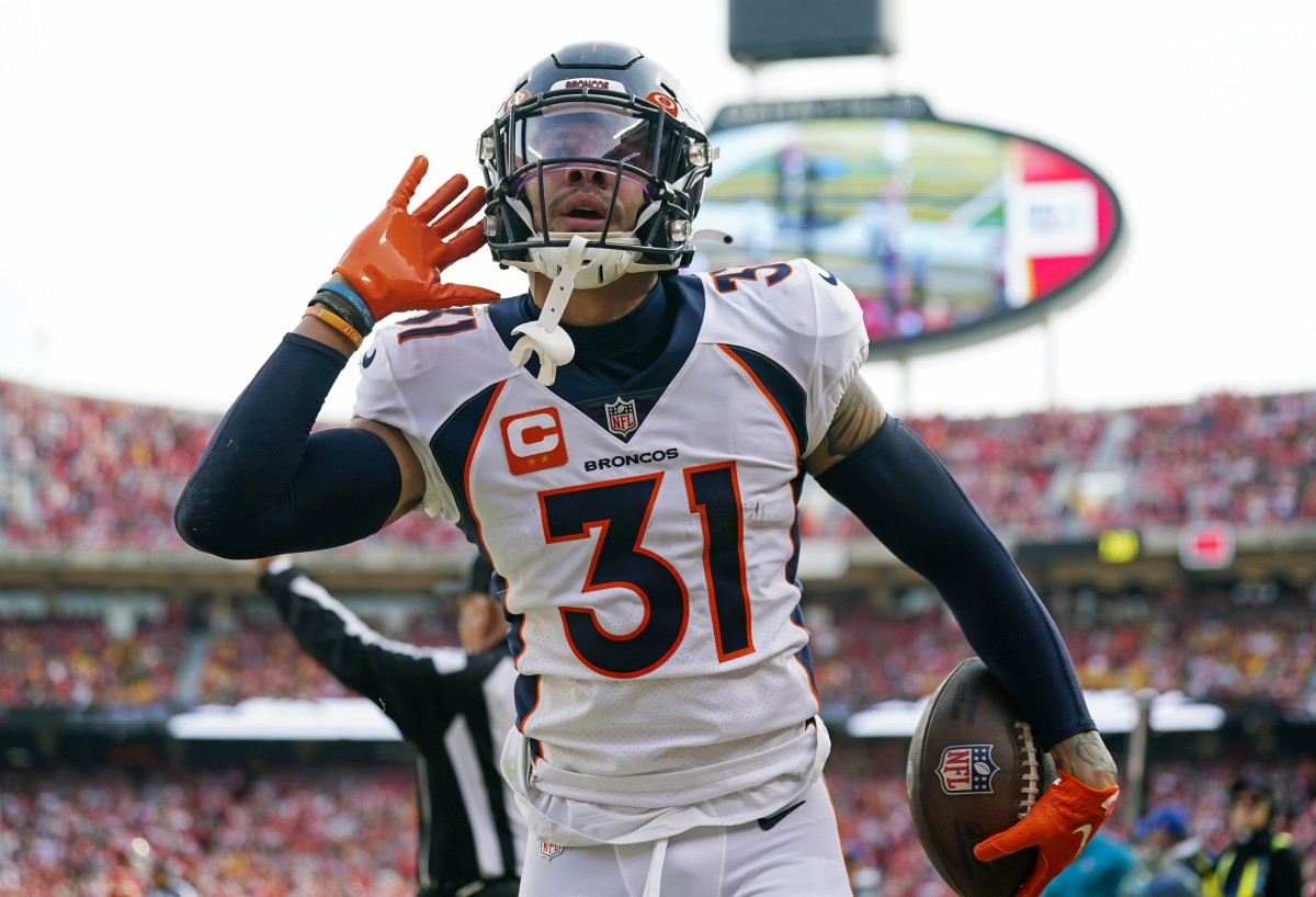 Jan 1, 2023; Kansas City, Missouri, USA; Denver Broncos safety Justin Simmons (31) celebrates after an interception during the first half against the Kansas City Chiefs at GEHA Field at Arrowhead Stadium.