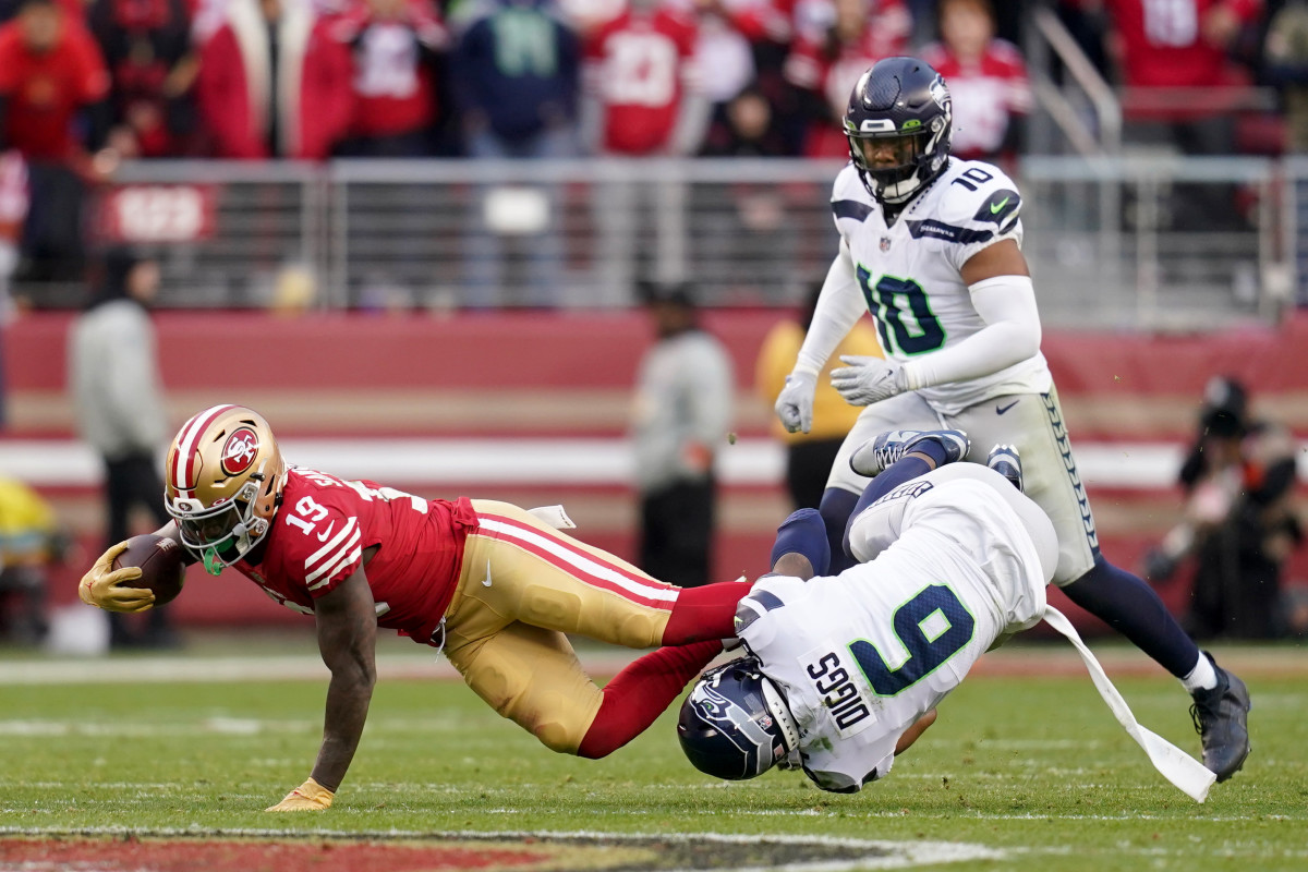 San Francisco 49ers wide receiver Deebo Samuel is tackled by Seattle Seahawks safety Quandre Diggs