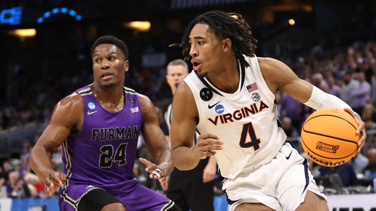 Virginia Cavaliers guard Armaan Franklin (4) dribbles the ballwhile defended by Furman Paladins forward Alex Williams (24) during the second half at Amway Center.