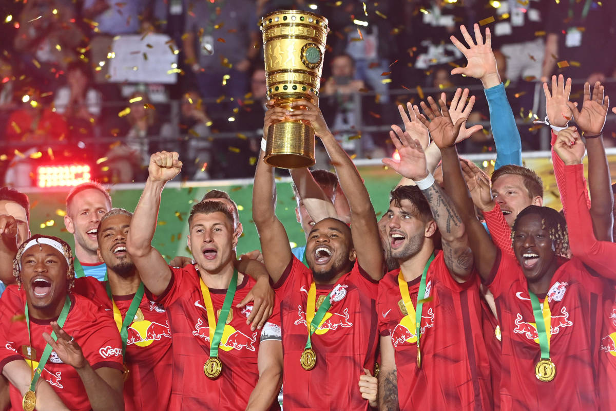Christopher Nkunku pictured (center) lifting the DFB-Pokal trophy after scoring in the 2023 final to help RB Leipzig beat Eintracht Frankfurt 2-0