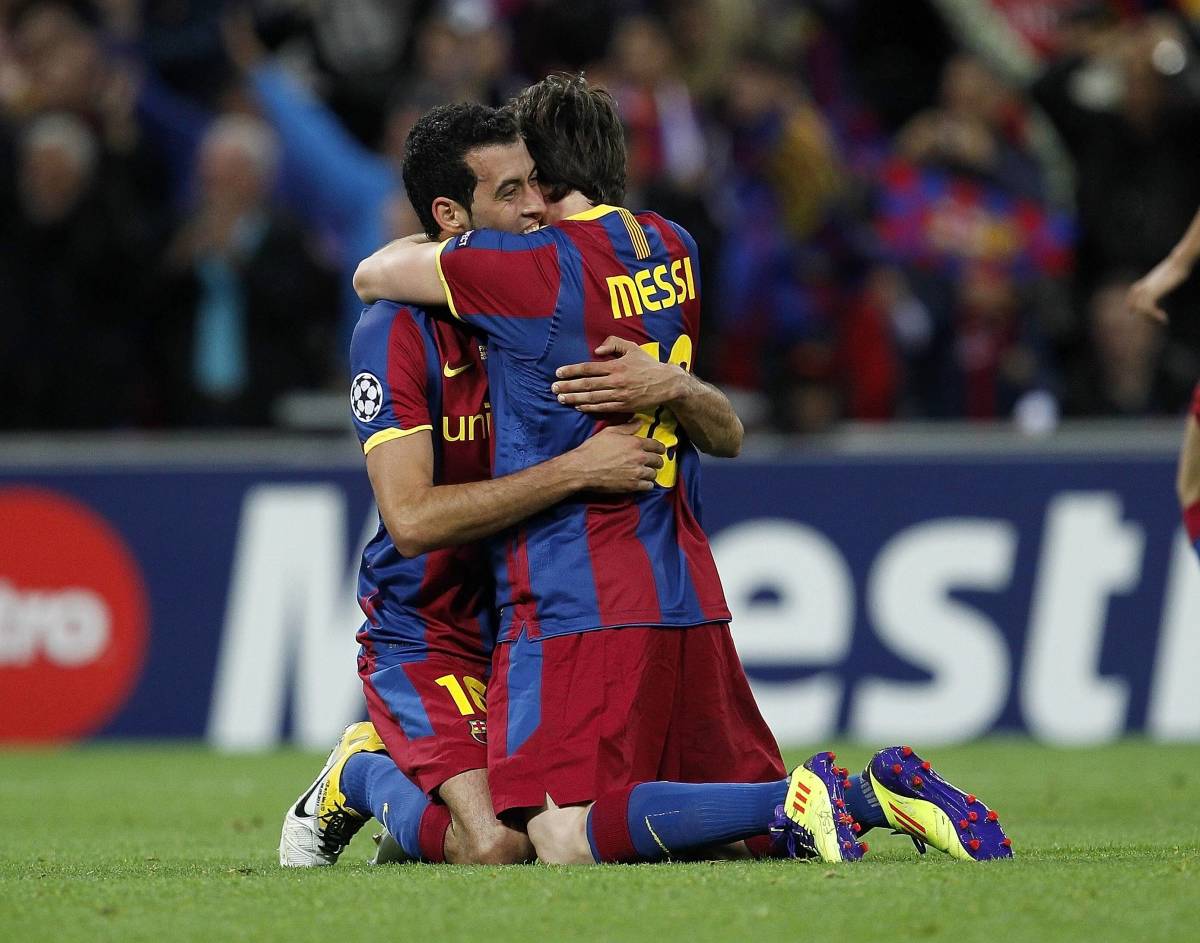 Sergio Busquets (left) and Lionel Messi pictured hugging during the 2011 UEFA Champions League final, which saw Barcelona beat Manchester United 3-1 in London