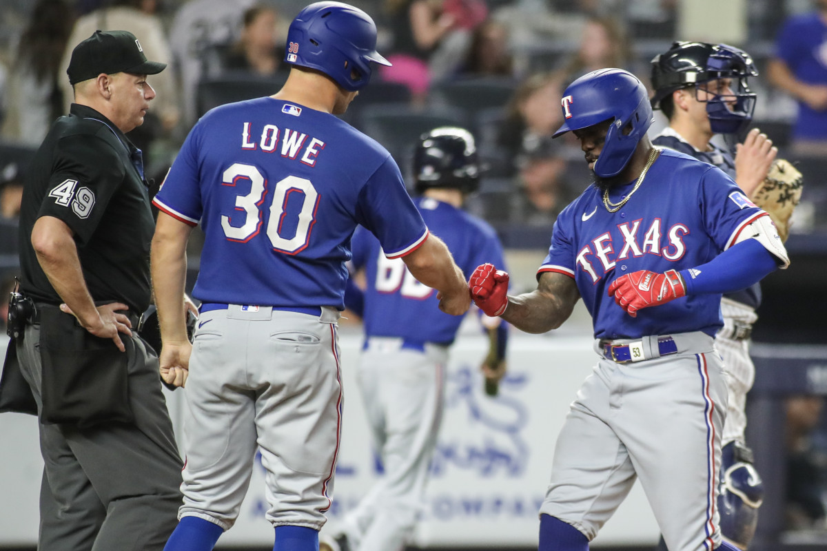 Jun 23, 2023; Bronx, New York, USA; Texas Rangers right fielder Adolis Garcia (53) celebrates with first baseman Nathaniel Lowe (30) after hitting a two run home run in the tenth inning against the New York Yankees at Yankee Stadium. Mandatory Credit: Wendell Cruz-USA TODAY Sports