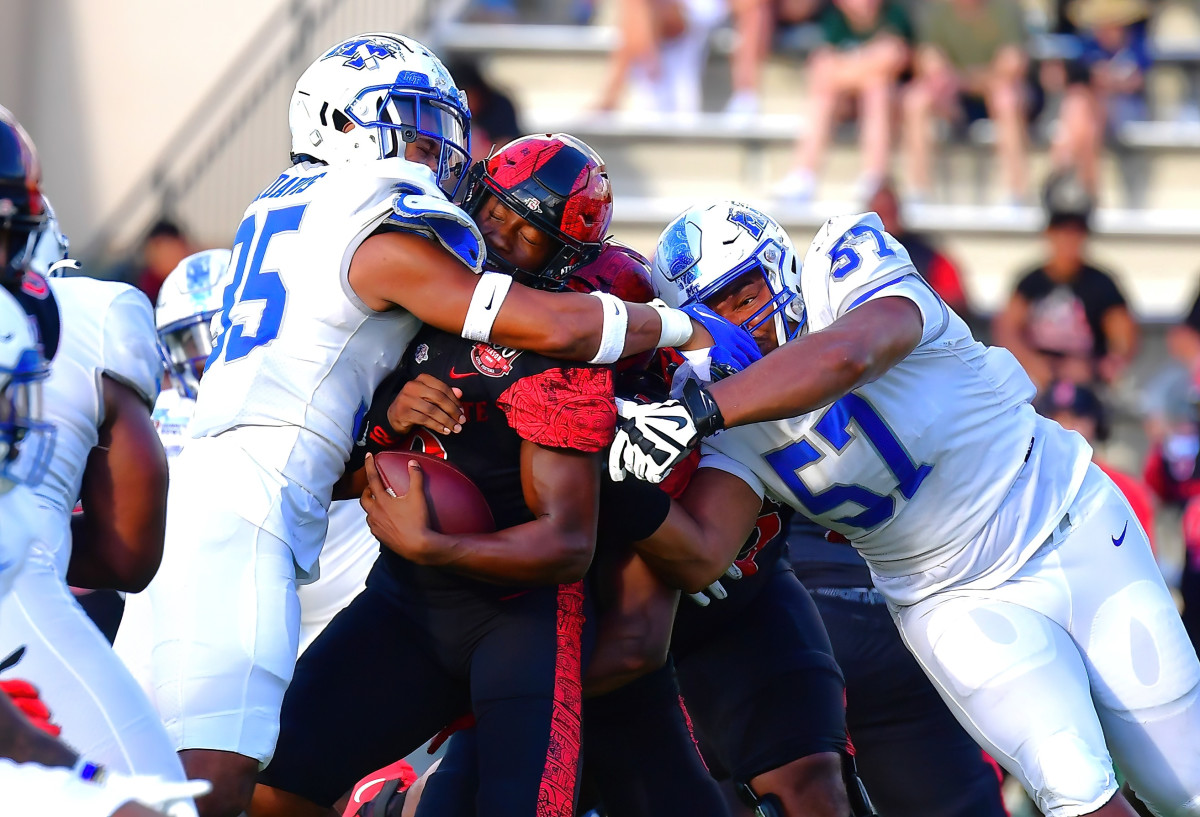 Middle Tennessee Blue Raiders linebacker Jalen Davis (35) and defensive tackle Marley Cook (57) sack San Diego State Aztecs quarterback Jalen Mayden (18) during the second quarter at Ching Complex.