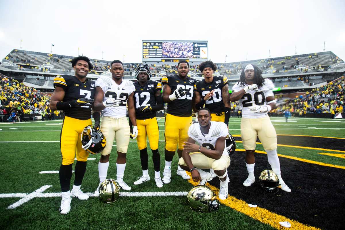Iowa wide receiver Tyrone Tracy, Jr. (3) Purdue running back King Doerue (22) Iowa defensive back D.J. Johnson (12) Iowa offensive lineman Justin Britt (63) Iowa defensive back Julius Brents (20) Purdue running back Alfred Armour (20) and Purdue wide receiver David Bell (3) pose for a photo after a NCAA Big Ten Conference football game between the Iowa Hawkeyes and Purdue, Saturday, Oct., 19, 2019, at Kinnick Stadium in Iowa City, Iowa. 191019 Purdue Iowa Fb 064 Jpg